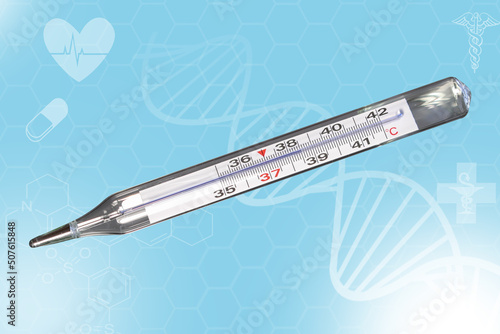 Analog clinical thermometer, mercury free, calibrated in degrees centigrade indicating a temperature of 38.5 degrees centigrade. Fever or illness concept photo
