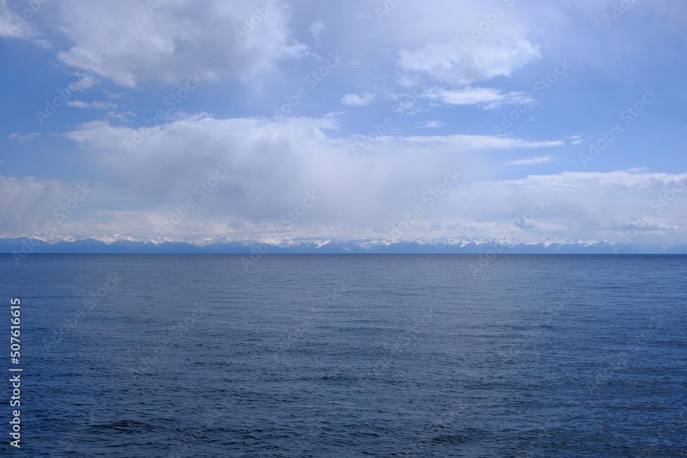 View of the snow-capped mountains of the eastern shore of Lake Baikal, May 2022