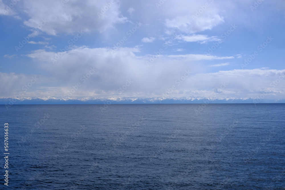 View of the snow-capped mountains of the eastern shore of Lake Baikal, May 2022 View of the snow-capped mountains of the eastern shore of Lake Baikal, May 2022