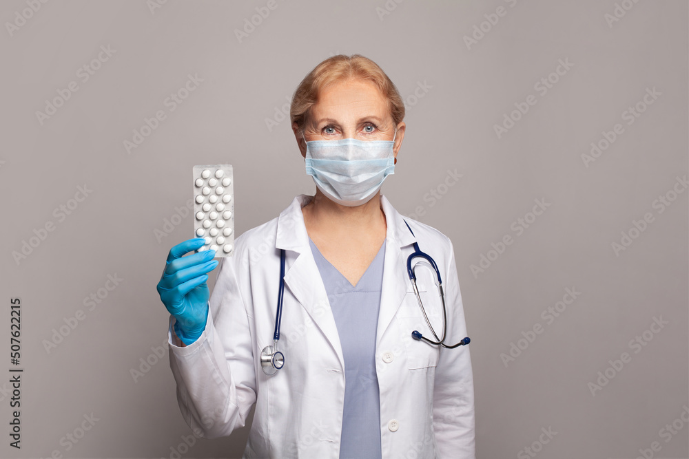 Picture of doctor giving white pills on grey banner background Picture of doctor giving white pills on grey banner background