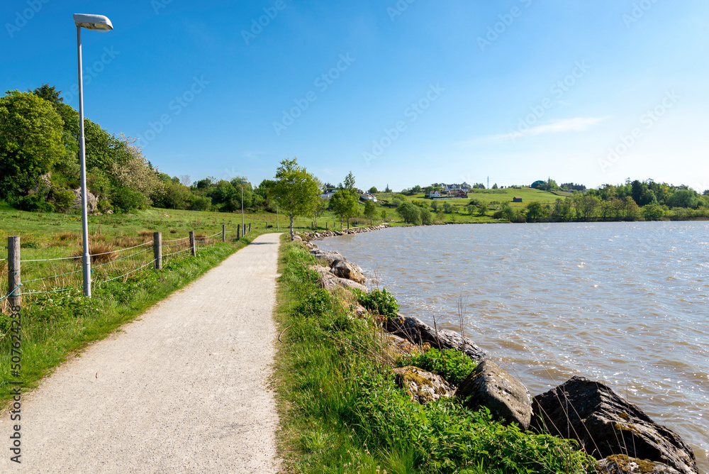 A gravel path around Halandsvatnet lake for walking, jogging, running and cycling activities, Stavanger, Norway, May 2018