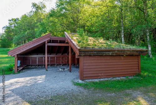 A roof covered shelter hut with a campfire circle in the middle in Halandsvatnet lake park, Stavanger, Norway, May 2018