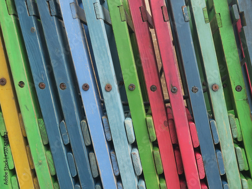 row of multicolored wooden chairs near a terrace in Amsterdam