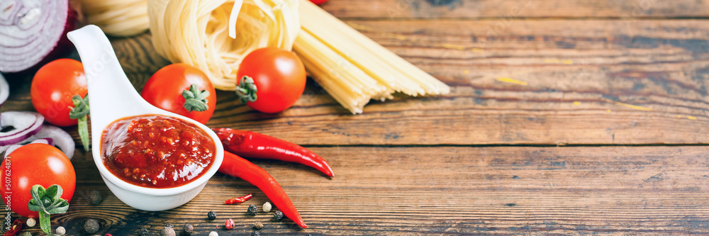 Tomato sauce and paste on a wooden background. Banner. Copy space Tomato sauce and paste on a wooden background. Banner. Copy space