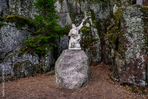 Vainamoinen playing on a kantele - statue of the hero of the epic Kalevala. Vyborg. Granite gorge. Monrepos park. photo
