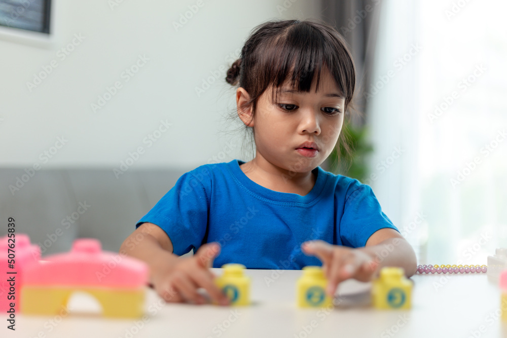 Asian child girl playing creative toy blocks for homeschooling Asian child girl playing creative toy blocks for homeschooling