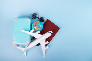 travel visa, documents for international flights, residence permit, immigration, passport, plane and luggage on a blue background with copy space