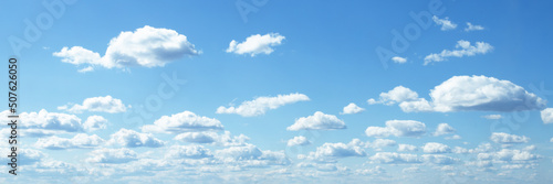 blue sky background banner, fluffy clouds on a summer day in sunlight