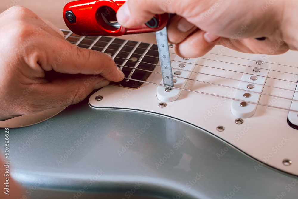 Guitar master changing or making electric guitar pickup height