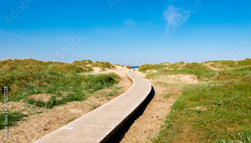 Obraz na płótnie A wooden boardwalk leading to Solastranden beach from the car park and hotel resort, Stavanger, Norway, May 2018 w salonie