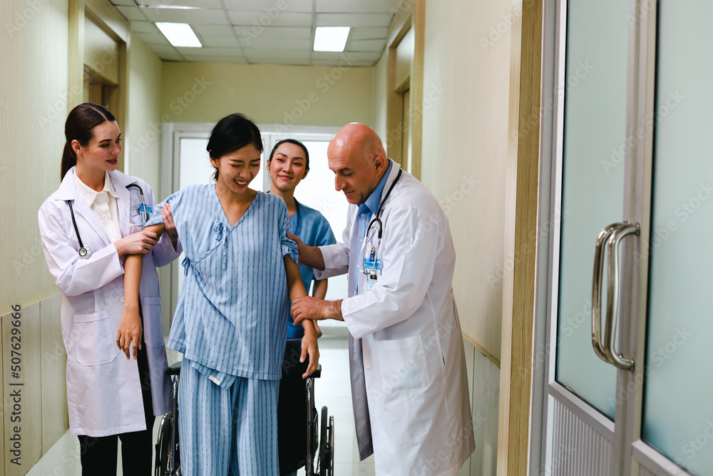 Doctor team talking to patient in wheelchair and ask about symptoms and treatment at hospital. Doctor team talking to patient in wheelchair and ask about symptoms and treatment at hospital.