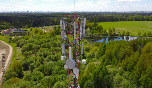 Aerial view of the tower of mobile communications, telecommunications and the 5g Internet. An iron head with locators and antennas. 25 May 2022, Minsk, Belarus