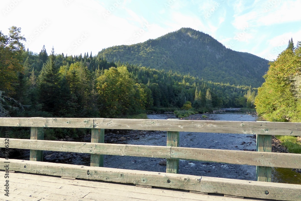 Jacques-Cartier National Park in province of Quebec, Canada, with green foliages, crystal clear water and mountains at the water’s edge of the Jacques-Cartier River Jacques-Cartier National Park in province of Quebec, Canada, with green foliages, crystal clear water and mountains at the water’s edge of the Jacques-Cartier River