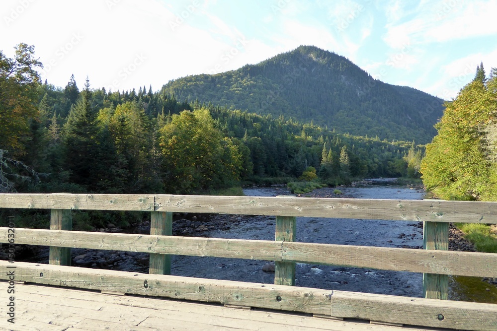 Jacques-Cartier National Park in province of Quebec, Canada, with green foliages, crystal clear water and mountains at the water’s edge of the Jacques-Cartier River