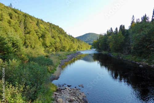 Jacques-Cartier National Park in province of Quebec  Canada  with green foliages  rocks and mountains at the water   s edge of the Jacques-Cartier River