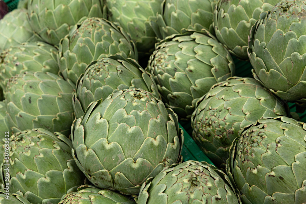Fototapeta premium Venta de alcachofas en puesto del mercado.