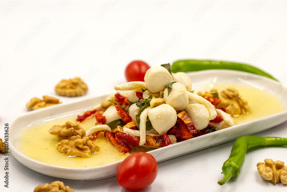 Specially prepared breakfast cheese. A special cheese plate prepared with olive oil, vegetables, walnuts and cheeses. close up Specially prepared breakfast cheese. A special cheese plate prepared with olive oil, vegetables, walnuts and cheeses. close up