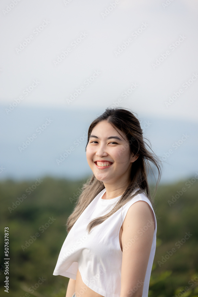 cute girl standing and playing with beautiful nature with clear sky on vacation They stood and took pictures happily. cute girl standing and playing with beautiful nature with clear sky on vacation They stood and took pictures happily.