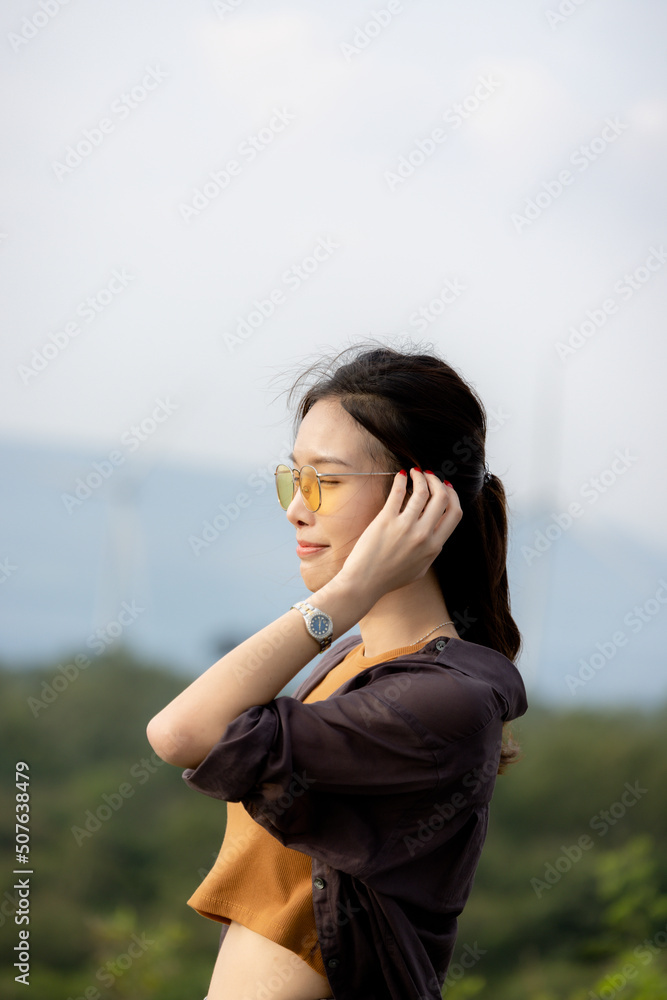 cute girl standing and playing with beautiful nature with clear sky on vacation They stood and took pictures happily. cute girl standing and playing with beautiful nature with clear sky on vacation They stood and took pictures happily.