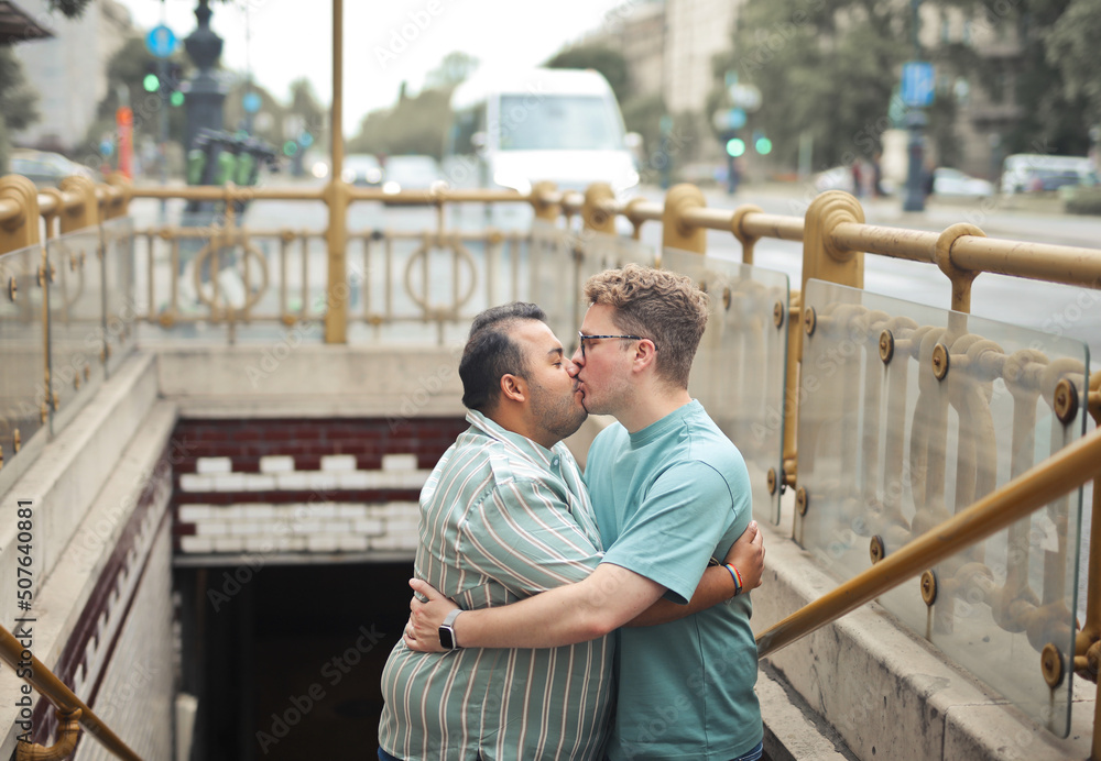 portrait of young homosexual couple kissing