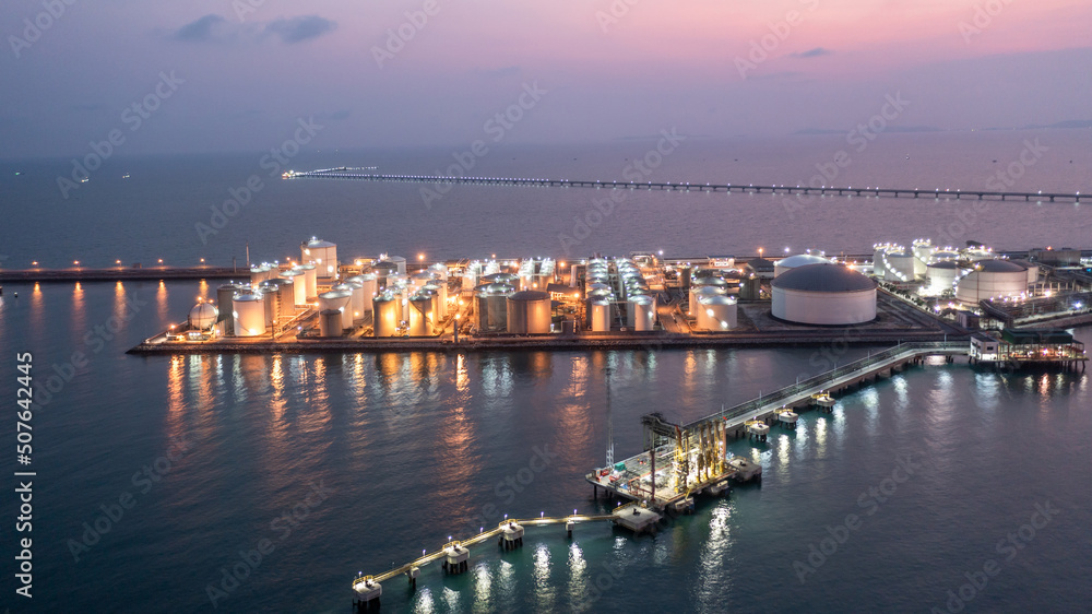 Aerial view oil terminal storage tank farm at night, Tank farm storage chemical petroleum petrochemical refinery product at oil terminal, Business commercial trade fuel and energy transport.