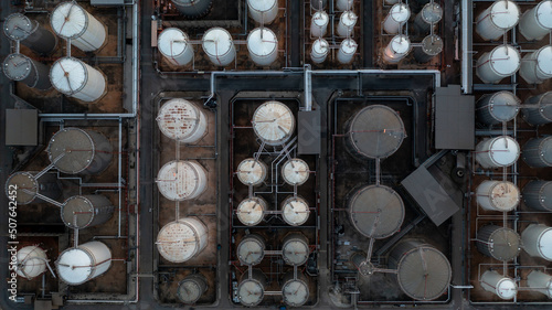 Aerial view fuel reservoirs petroleum industrial zone and metal exhaust pipes oil refinery factory, Oil storage tank farm storage chemical petroleum petrochemical refinery product terminal company