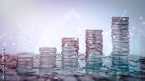 Double exposure of graph and rows of coins for finance, saving, banking, business concept.