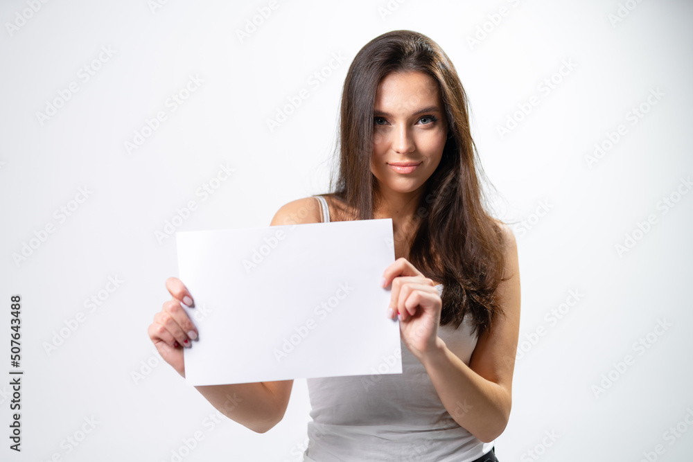 Young pretty lady with white paper. Beautiful girl woman showing thumbs up sign. Young pretty lady with white paper. Beautiful girl woman showing thumbs up sign.