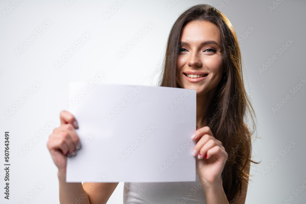 Beautiful girl woman showing thumbs up sign. Young pretty lady with white paper. Beautiful girl woman showing thumbs up sign. Young pretty lady with white paper.