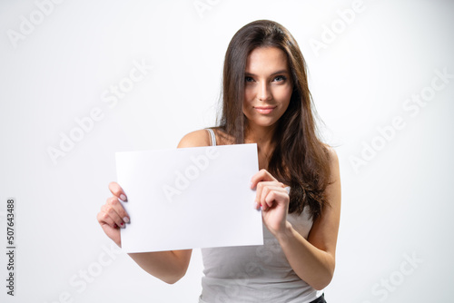 Young pretty lady with white paper. Beautiful girl woman showing thumbs up sign.