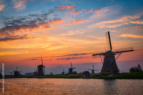 Netherlands rural landscape with windmills at famous tourist site Kinderdijk in Holland on sunset with dramatic sky