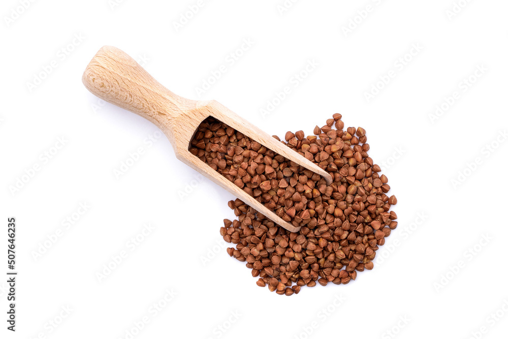 Top view of buckwheat seeds and wooden scoop isolated on white background Top view of buckwheat seeds and wooden scoop isolated on white background