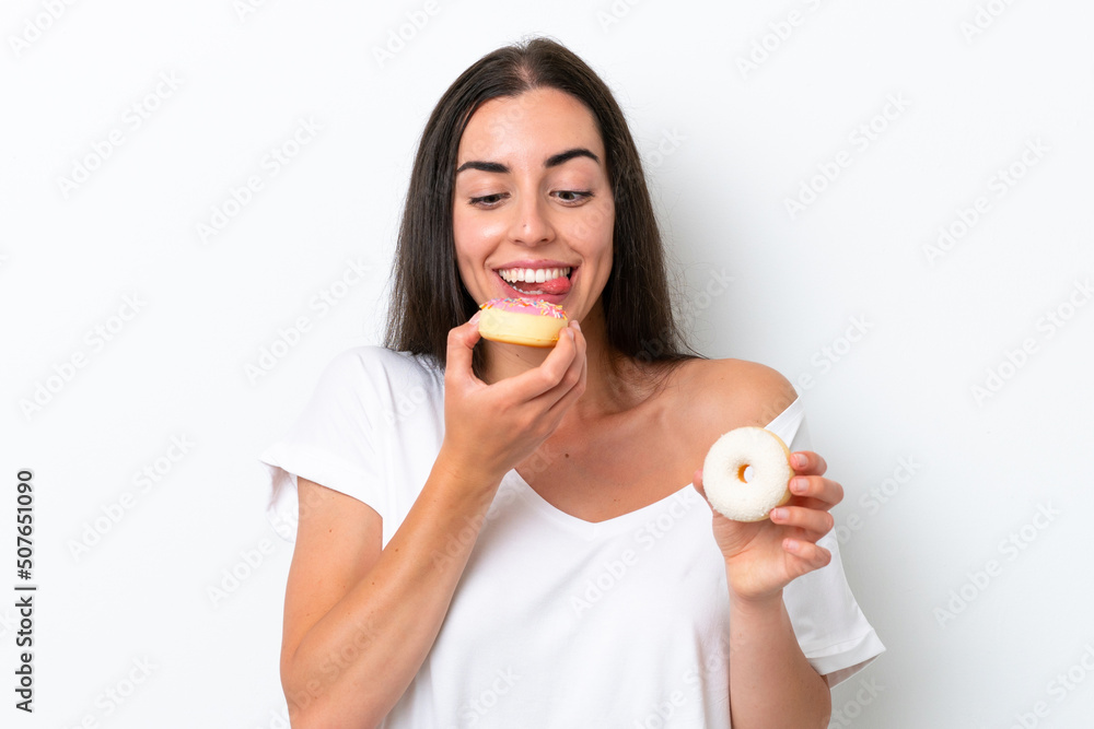 Young caucasian woman isolated on white background holding a donut Young caucasian woman isolated on white background holding a donut