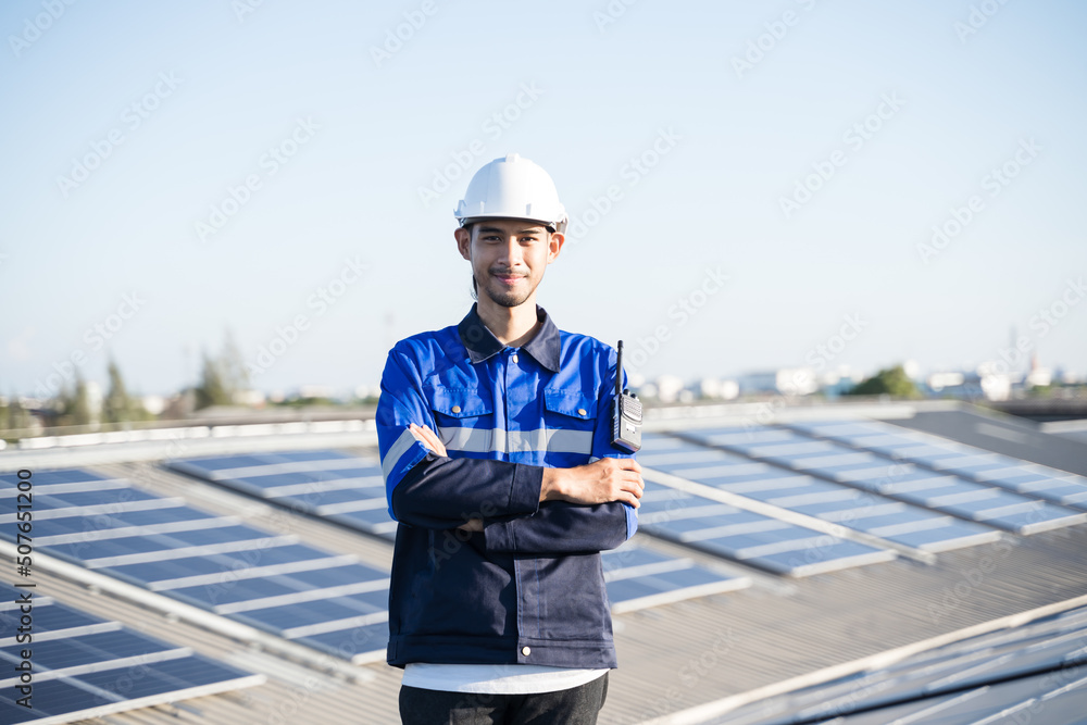 Portrait of Asian engineer on background field of photovoltaic solar panels solar cells on roof top factory. Portrait of Asian engineer on background field of photovoltaic solar panels solar cells on roof top factory.
