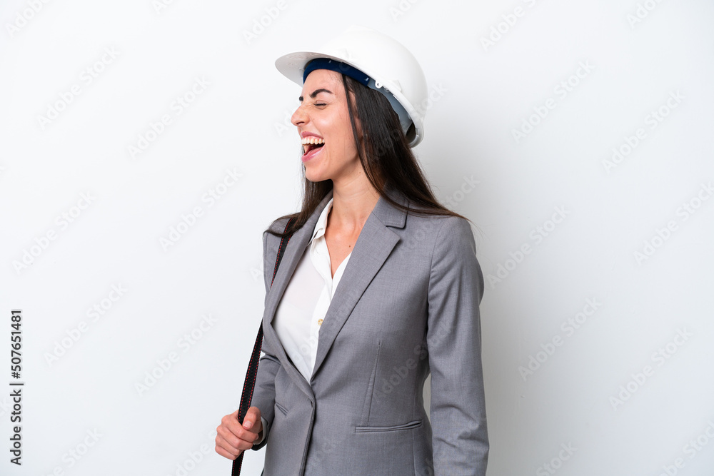 Young architect caucasian woman with helmet and holding blueprints isolated on white background laughing in lateral position Young architect caucasian woman with helmet and holding blueprints isolated on white background laughing in lateral position