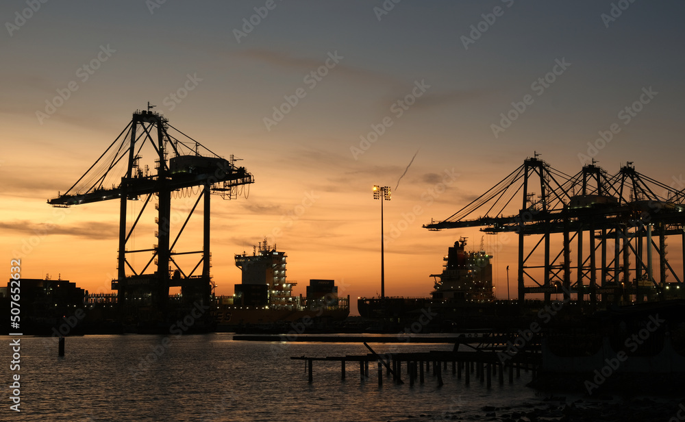 A picture of sunset view silhoutte and long exposure port terminal with ship insight