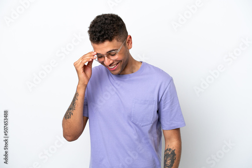 Young caucasian Brazilian man isolated on white background laughing