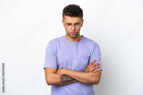 Young caucasian Brazilian man isolated on white background feeling upset