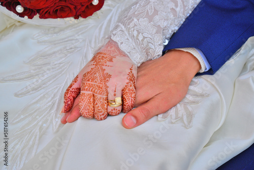 Close up of moroccon couple's hands at a wedding, concept of marriage, moroccan wedding. photo