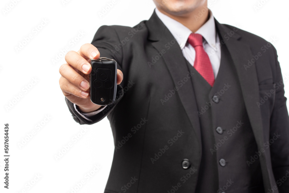 Portrait of a confident business man in black suit holding the keys of the car isolated on white background. Portrait of a confident business man in black suit holding the keys of the car isolated on white background.