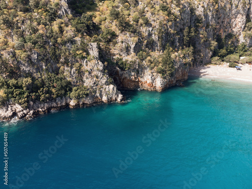 Sea waves on the wild rocky coast. Beautiful seascape. Travel concept. Seascape on the background of the wild rocky coast. Azure water and rocks. Aegean Sea, Turkey. Postcard view. Drone shot