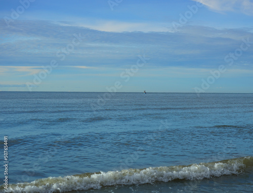 seascape or ocean with beach in horizontal scenic view and sun