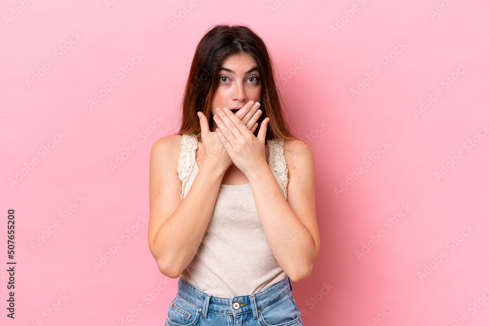 Young caucasian woman isolated on pink background covering mouth with hands Young caucasian woman isolated on pink background covering mouth with hands