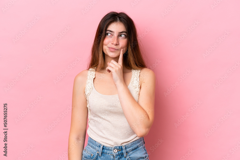 Young caucasian woman isolated on pink background and thinking Young caucasian woman isolated on pink background and thinking