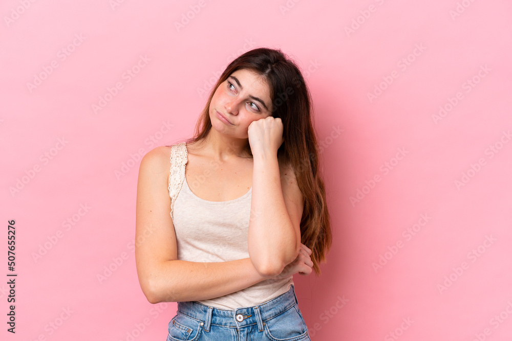 Young caucasian woman isolated on pink background with tired and bored expression Young caucasian woman isolated on pink background with tired and bored expression