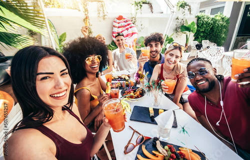 Photography Multiracial group of friends enjoying meal having backyard dinner party - Young