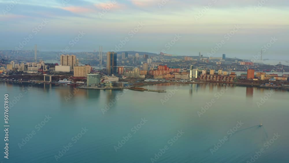 Marine facade of the city of Vladivostok. Drone view of the coast at sunset. Residential development, modern construction, embankment. Egersheld Peninsula Marine facade of the city of Vladivostok. Drone view of the coast at sunset. Residential development, modern construction, embankment. Egersheld Peninsula