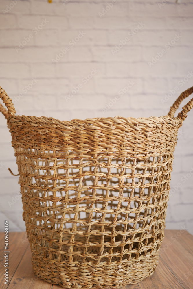 Obraz premium Clothes in basket on floor against a wall 