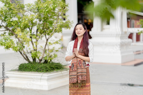 Photography portrait Asian buddhist woman wearing traditional dress of Thailand praying at W