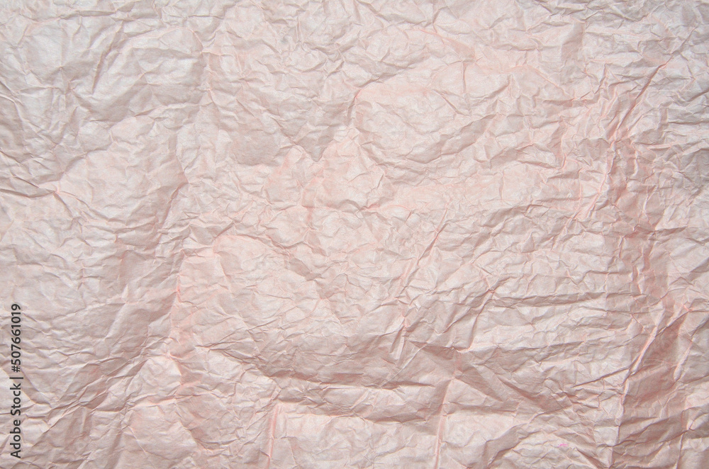 Crumpled pale pink wrapping paper texture background. Full frame of  creased packaging paper texture - abstract backdrop. Recycling concept or element of creative design